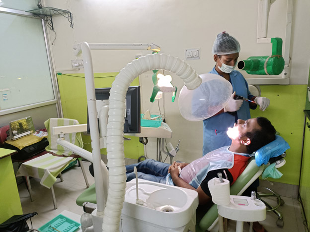 The best dentist in Kolkata is examining a patient at Teeth Care Multispeciality Dental Clinic. A proper care is given.